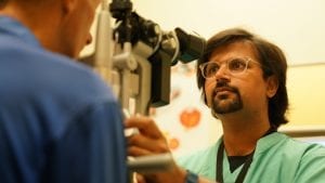 dr mehul patel giving an eye exam